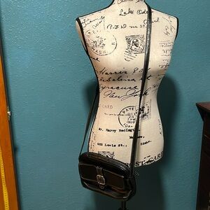 Small black crossbody purse, faux leather look w/silver colored metal buckle